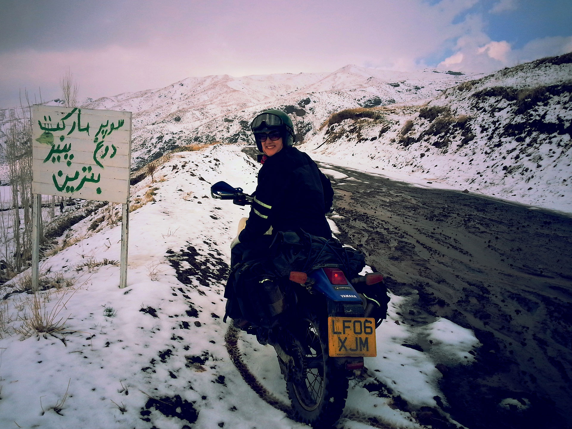 Author Lois Pryce in snowy Iranian mountains on her motorbike adventure